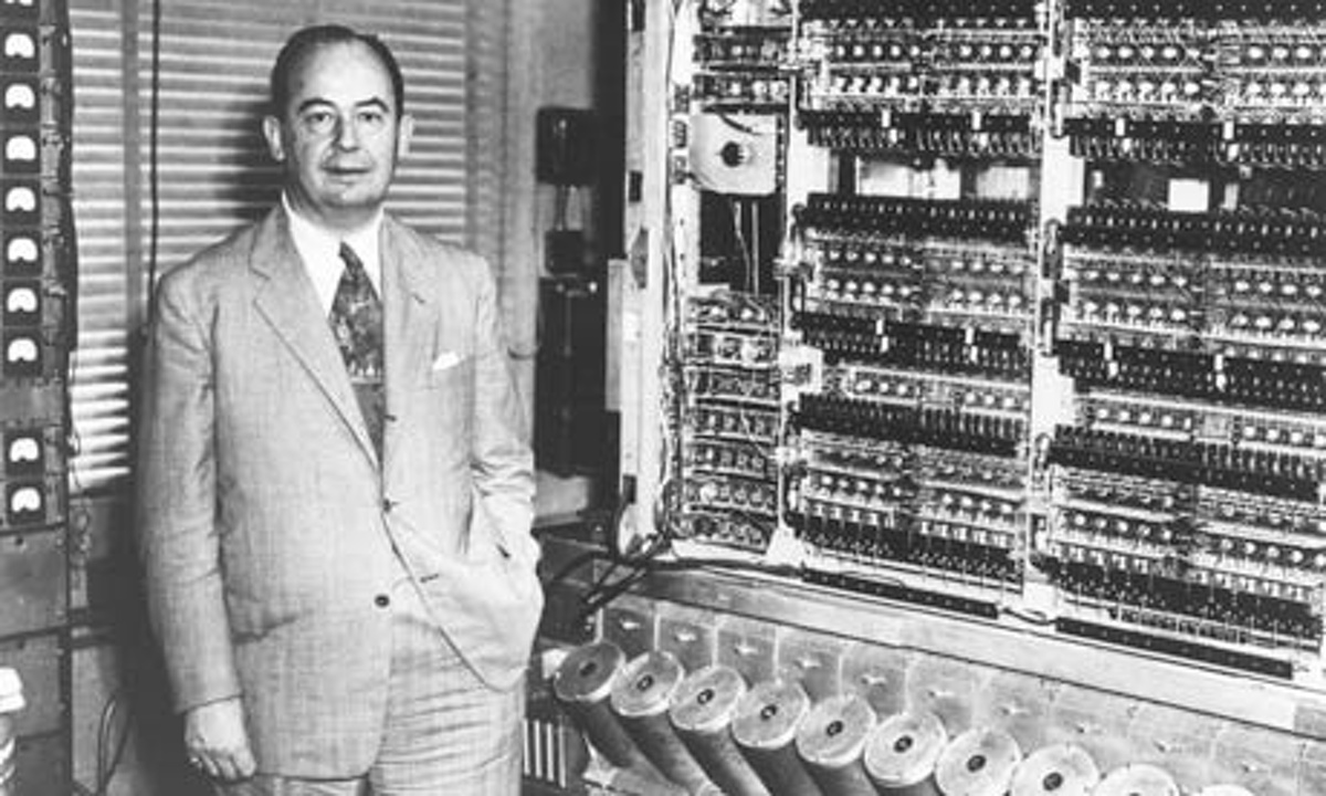 Dr. John von Neumann standing in front of his stored-program computer.